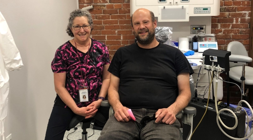 A patient and a dental care professional at the C.H.A.N.C.E. Clinic.