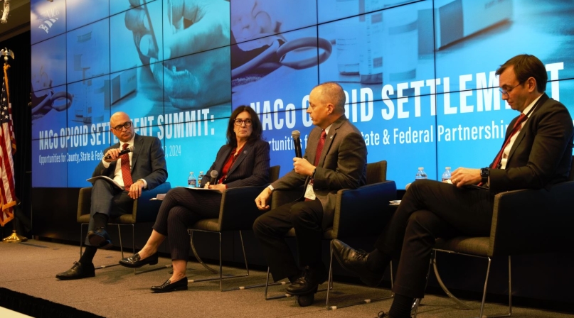 Tony McDowell (right), executive director, Virginia Opioid Abatement Authority, speaks to Stephen Acquario, executive director, New York State Association of Counties and Gina Nikkel, executive director, Association of Oregon Counties Jan. 10 in Washington, D.C.  Photo by Charlie Ban