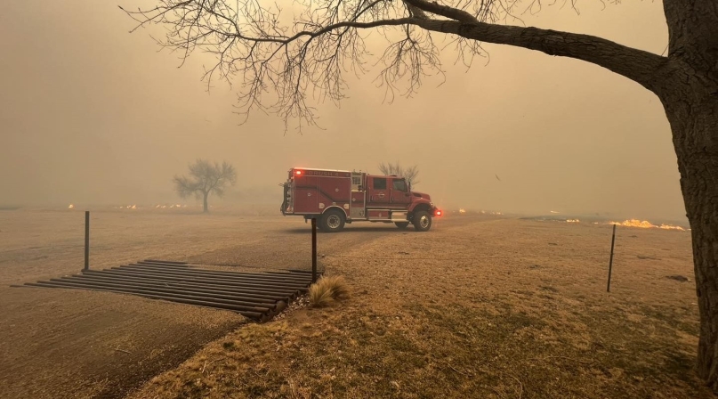 A firetruck parks in West Texas as smoke billows from wildfires. Photo courtesy of Greenville, Texas Fire-Rescue