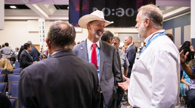 Ravalli County, Mont. Commissioner Greg Chilcott talks to colleagues before the General Session at the 2022 NACo Annual Conference. Photo by Denny Henry