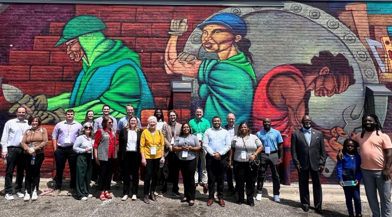Peer exchange attendees visit a mural during a walking tour of Ramsey County, Minn.