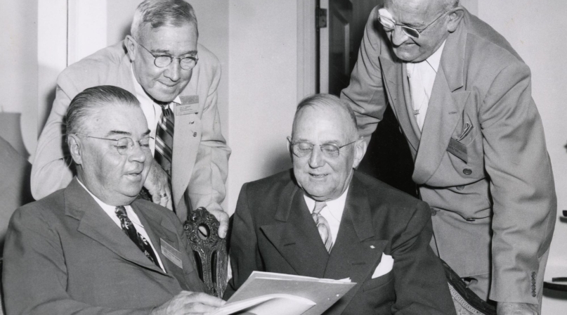 G. Claiborne Blanton, Joseph F. Hammond, Harry Bartell and Stanley Martin review the program for the 1949 National Association of County Officers Annual Conference.