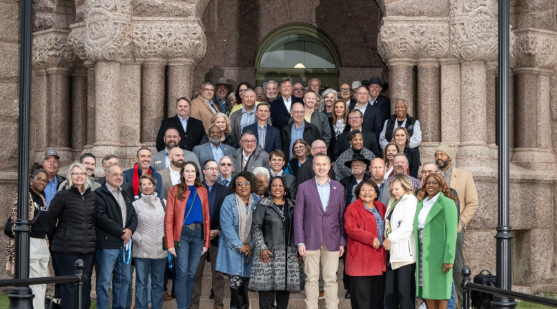 President J.D. Clark (front row, in red jacket), and the NACo Board of Directors pose in front of the Wise County, Texas Courthouse during the 2025 Fall Board Meeting. Photo by Joe Duty