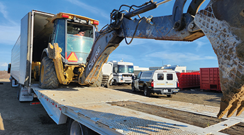 A stolen backhoe being unloaded in March 2024 from a semitruck, recovered by law enforcement in Tulare County, Calif. Photo courtesy of the Tulare County Sheriff’s Office
