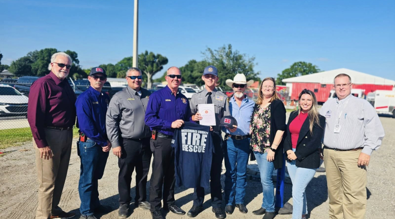 After completing the Okeechobee High School CTE Fire Program, Braxton Lewis (pictured in the middle) was offered a job with Fire Rescue. Photo courtsey of Okeechobee County