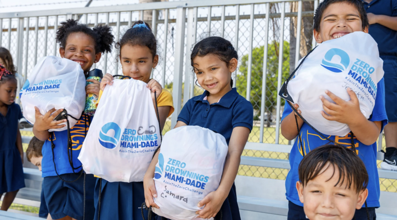 Children participating in Miami-Dade County, Fla.’s Zero Drowning initiative show off their drawstring backpacks.