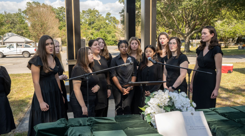 Choir members sing at a ceremony honoring the county's indigent who went unclaimed after their deaths.