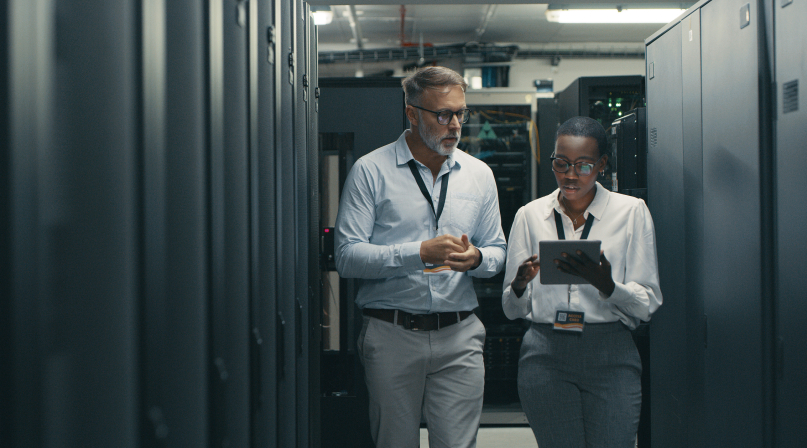 Shot of a man and woman using a digital tablet while working in a data center