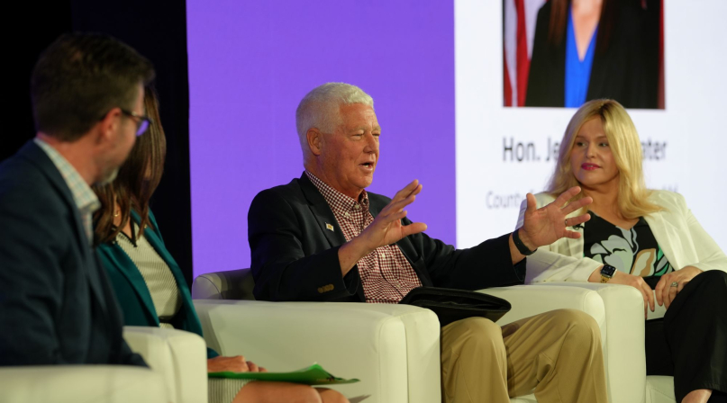 Mason County, W.Va. Commissioner Rick Handley describes the extent to which his Legislative preempted local control on data centers during an educational summit July 18. Heather Coil, of the Data Center Coalition, is to his left. Photo by Charlie Ban