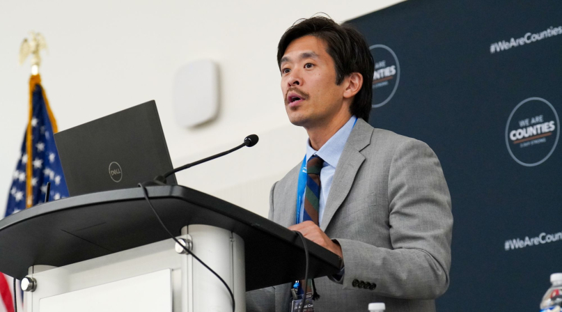 Manatt Health Managing Director Richard Cho outlines opportunities for housing development while addressing the Large Urban County Caucus. Photo by Leon Lawrence III