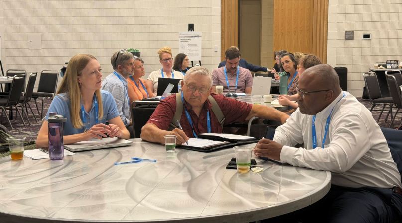 Courtney Biere of the Iowa State Association of Counties, Mills County, Iowa Supervisor Richard Crouch and Wake County, N.C. Deputy County Manager Duane Holder discuss opioid settlements. Photo by Cameron Leonard
