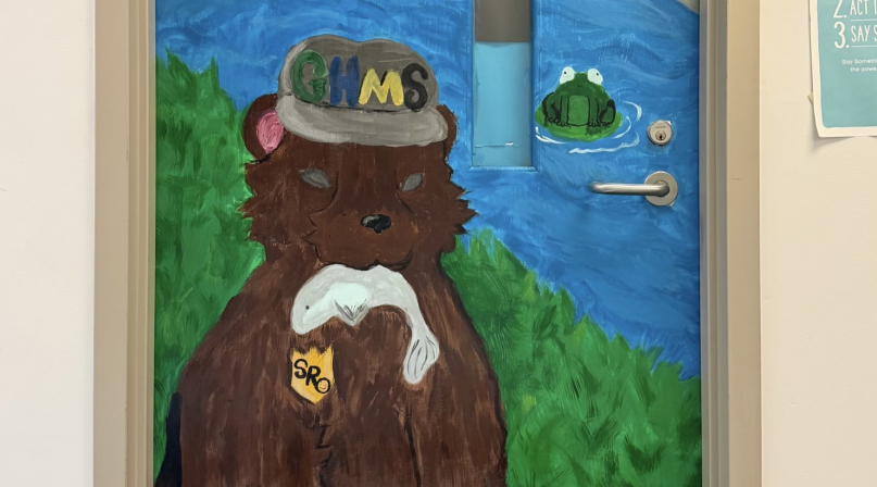 Orange County, N.C.’s Youth Deflection Program connected a youth referred for graffiti with a local arts nonprofit, where the young person received mentorship and found a positive outlet for their artistic talents, including helping paint this mural on a school resource officer’s door.