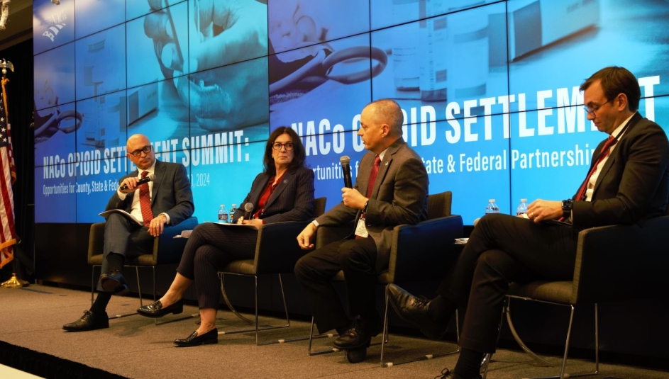 Tony McDowell (right), executive director, Virginia Opioid Abatement Authority, speaks to Stephen Acquario, executive director, New York State Association of Counties and Gina Nikkel, executive director, Association of Oregon Counties Jan. 10 in Washington, D.C.  Photo by Charlie Ban