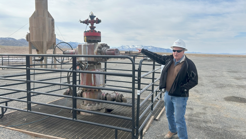 John McLennon shows off a geothermal wellhead on the Utah FORGE site in Beaver County, Utah. Photo by Charlie Ban
