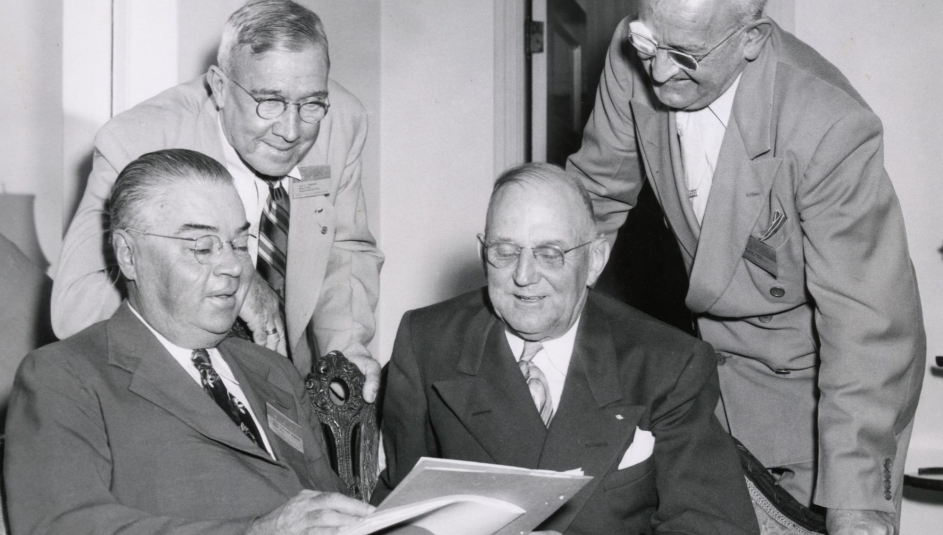 G. Claiborne Blanton, Joseph F. Hammond, Harry Bartell and Stanley Martin review the program for the 1949 National Association of County Officers Annual Conference.