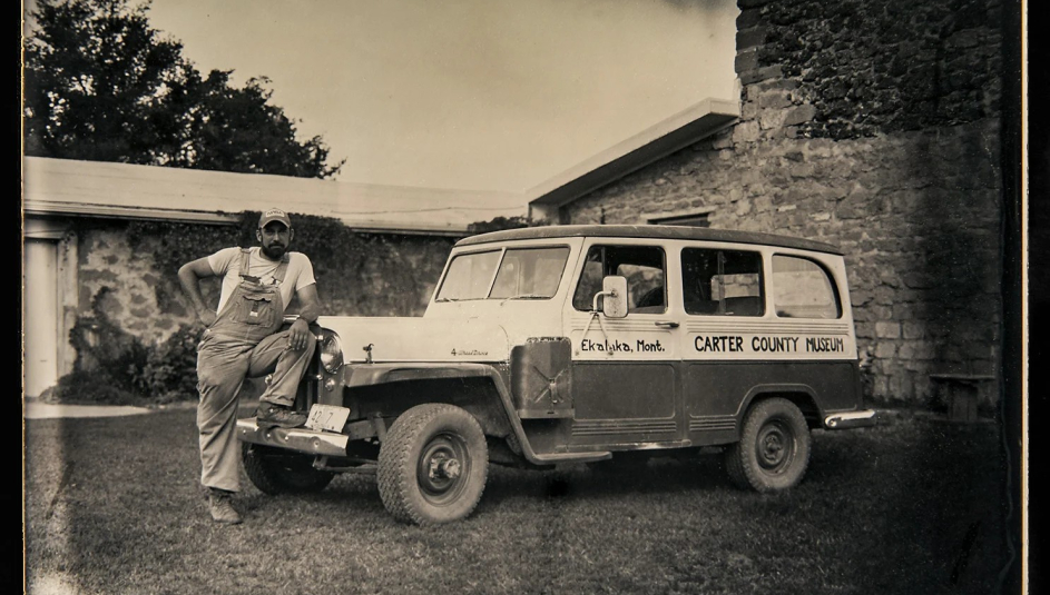 Curator Nathan Carroll poses with the Carter County Museum’s field vehicle, purchased in the 1960s.