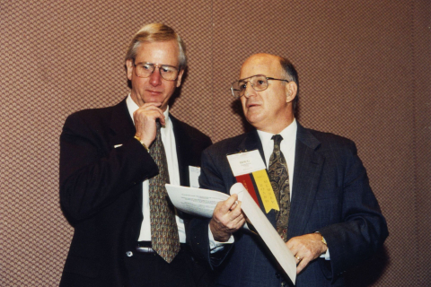 Executive Director Larry Naake (left) and President Doug Bovin confer during the 1996 Annual Conference.